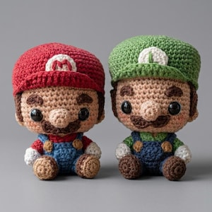 May include: Two crochet dolls featuring characters with large heads and small bodies. One doll wears a red cap with an M, a red shirt, and blue overalls. The other doll wears a green cap with an L, a green shirt, and blue overalls. Both have brown hair.