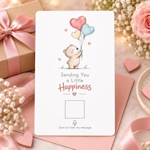 May include: A white rectangular greeting card featuring a cartoon bear holding three heart-shaped balloons in pink, yellow, and blue. The text reads Sending You a Little Happiness above a square frame, a microphone icon, and the text Scan to listen my message.