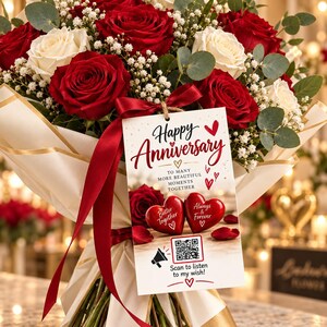 May include: A bouquet of red and white roses with baby's breath and eucalyptus leaves, wrapped in cream paper with a red ribbon. A rectangular tag attached reads: Happy Anniversary, To many more beautiful moments together, Better Together, Always & Forever.