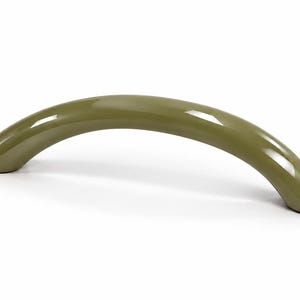 May include: A curved, arch-shaped cabinet handle with a smooth, glossy olive green finish. The hardware features a solid, rounded profile that tapers slightly at both ends, providing a clean and simple aesthetic for furniture or cabinetry.