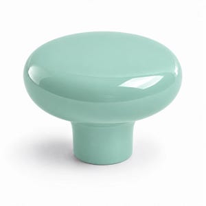 May include: A solid mint green cabinet knob with a smooth, glossy finish. The knob features a wide, rounded, mushroom-shaped top that tapers down into a cylindrical base, creating a simple, uniform, and reflective surface across the entire object.