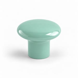May include: A solid mint green cabinet knob with a smooth, glossy finish. The hardware features a wide, rounded top surface that tapers down into a cylindrical base, creating a simple, functional shape for furniture or cabinetry.