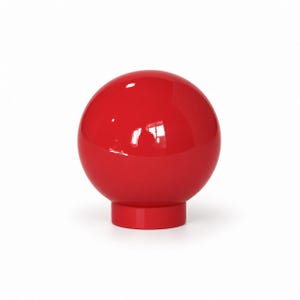 May include: A solid, glossy red sphere mounted on a small, cylindrical red base. The surface of the sphere is smooth and reflective, showing light highlights that indicate a polished finish. The object is uniform in color and shape throughout.