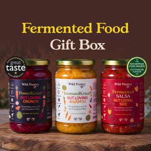 May include: Three glass jars of Wild Pantry fermented food labelled PowerKraut, ImmuniKraut, and Fermented Salsa. The jars feature gold lids and colourful labels with text including Gut Loving Crunch, Warmth, and Side, plus award seals for 2026.
