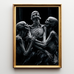May include: A framed wall art print featuring three grey, skeletal figures with hollow eyes and open mouths, positioned in a cluster against a dark background. The figures have elongated limbs and visible rib cages, all enclosed in a thin gold frame.