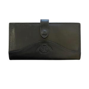 May include: A black leather wallet with a flap closure. The wallet features a curved design at the base and a logo in the centre. The rectangular wallet appears to be made of high-quality leather.