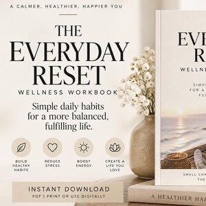 May include: A wellness workbook titled The Everyday Reset with a cream-colored cover featuring black text and a photograph of a person sitting by the ocean. The cover includes the subtitle Simple daily habits for a more balanced, fulfilling life.