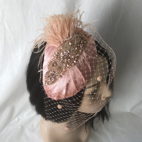 Vintage style blush pink peach ostrich feather fascinator half hat with dotted birdcage veil for mother of the bride, bridal wedding hat