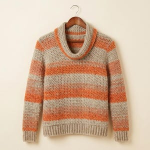 May include: A long-sleeved crochet sweater featuring a cowl neckline and horizontal stripes in alternating shades of beige and bright orange. The garment is constructed with a textured stitch pattern and includes ribbed cuffs and a ribbed hemline.