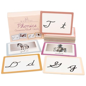 May include: A set of Maritas Phonics Cursive Flash Cards featuring a storage box and multiple rectangular cards. The cards display uppercase and lowercase cursive letters, as well as images of a zebra and a robot with their names written below.