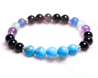 Pulseira de proteção à saúde com turquesa, turmalina negra, fluorita e quartzo fumê.