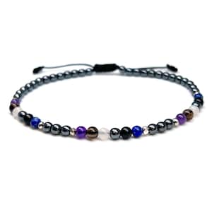 May include: A black beaded bracelet with a variety of colored gemstones, including amethyst, smoky quartz, white moonstone, black onyx, and lapis lazuli.