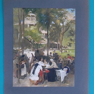 May include: An impressionistic painting of a park scene with people gathered around tables, trees, and a baby carriage. A harpist plays in the background. The artwork is framed in a gray mat.