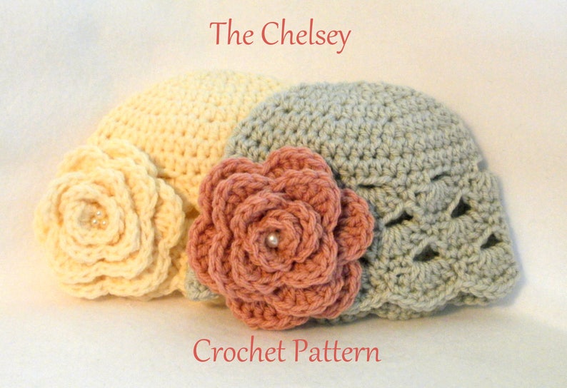 May include: Three crocheted hats in cream, dusty rose, and grey, each adorned with a large, decorative flower. The hats are handmade, with the text "The Chelsey Crochet Pattern" in red.