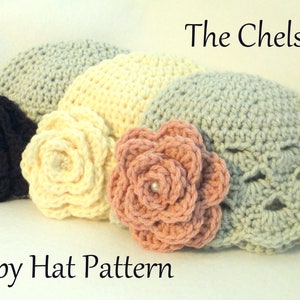 May include: Four crocheted baby hats in various colors: navy, cream, light pink, and gray. Each hat features a large, decorative crocheted flower. The text "The Chelsey" and "Baby Hat Pattern" are visible.