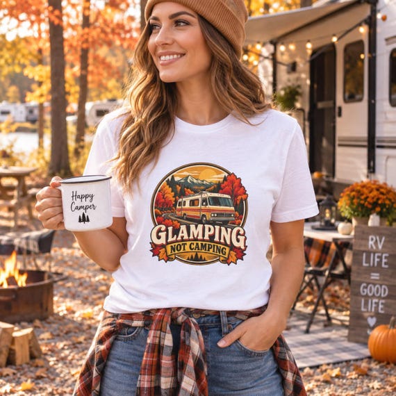 Woman wearing Glamping Not Camping shirt at autumn RV campsite