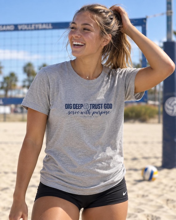 Woman wearing Serve With Purpose volleyball tee on outdoor sand court