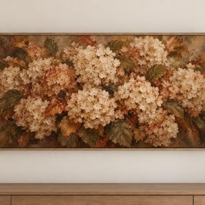 May include: A rectangular wall art piece featuring a detailed painting of clustered hydrangea flowers in muted cream, beige, and soft brown tones, interspersed with dark green and rust-colored leaves, all enclosed within a thin, light-toned wooden frame.