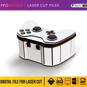 Può includere: Una scatola portaoggetti tagliata al laser, bianca e marrone scuro, a forma di controller per videogiochi. La parte superiore presenta una superficie bianca con levette analogiche marrone scuro, un D-pad marrone scuro e quattro tasti colorati A, B, X, Y. Spessore 3 mm.