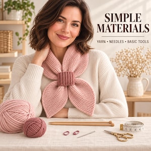 May include: A light pink knitted scarf secured with a matching ribbed ring, accompanied by two balls of yarn, wooden knitting needles, a metal needle, two stitch markers, a pair of scissors, and a measuring tape showing 4 inches of length.