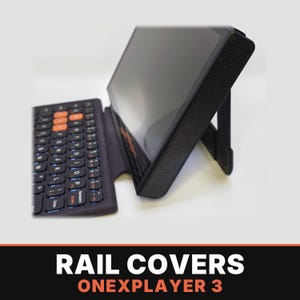 May include: A black handheld gaming console with a textured finish, featuring an attached keyboard with orange keys and a kickstand supporting the screen. The text RAIL COVERS ONEXPLAYER 3 is displayed in white and orange at the bottom.