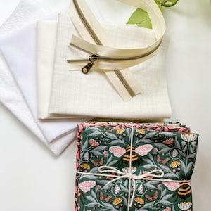 Flat lay of the materials needed to make the Honeycomb Pillow including fabric, zipper, interfacing, and batting.
