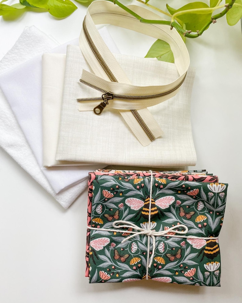 Flat lay of the materials needed to make the Honeycomb Pillow including fabric, zipper, interfacing, and batting.