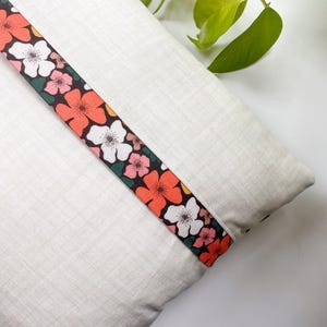 Back view of the Honeycomb Pillow showing the lapped zipper closure and colorful accent fabric, displayed on a white table.