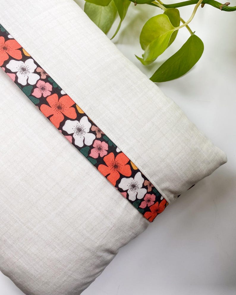 Back view of the Honeycomb Pillow showing the lapped zipper closure and colorful accent fabric, displayed on a white table.