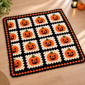 May include: A rectangular crochet blanket featuring a repeating pattern of white square motifs, each centered with an orange jack-o'-lantern pumpkin. The blanket is bordered by a thick black crochet edge with a scalloped trim in orange.