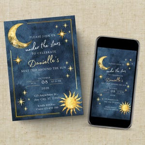 May include: A rectangular invitation card and a smartphone displaying the same design, featuring a dark blue watercolour background with gold foil accents of a crescent moon, a sun, and stars, with text reading "Please join us under the stars to celebrate Danielle's next trip around the sun" on October 8, 2026.