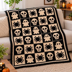 May include: A rectangular crochet blanket featuring a checkerboard pattern of black and cream squares. Each square displays a repeating motif of a ghost, a skull, or a spider. The blanket has a solid black border framing the entire design.