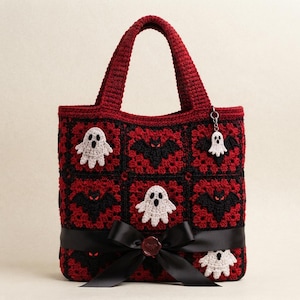 May include: A handmade crochet tote bag featuring a grid of red and black granny squares. The bag is decorated with white ghost appliqués and black bat motifs with red eyes. A black satin ribbon is tied in a bow across the front lower section.