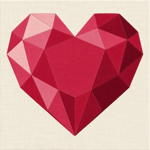 May include: A geometric heart wall art piece composed of various triangular fabric segments in shades of pink, magenta, and deep red. The heart features visible stitched seams between each fabric panel, set against a plain off-white background.