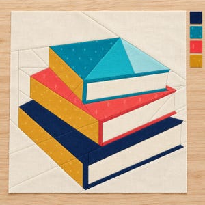 May include: A fabric quilt block pattern featuring a stack of three books in shades of teal, red, and navy blue with yellow accents. The books are set against a cream background with visible seam lines. Small fabric swatches are shown on the side.