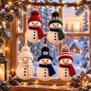 May include: Five hanging snowman ornaments made of white knit fabric. Each snowman features a knit hat with a pom-pom, a matching knit scarf, three black button accents, and an orange nose. The hats vary in color including red, green, cream, navy blue, and a red and white striped pattern.