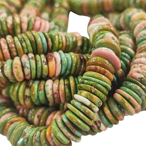 May include: A strand of disc-shaped beads featuring a variegated pattern of green, pink, and tan colors. The beads are arranged in a dense, coiled formation, showcasing a smooth, rounded edge and a flat profile on each individual bead piece.