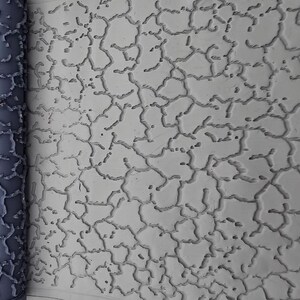 Peut inclure: Un rouleau à motif cylindrique gris foncé placé à côté d'une surface plane gris clair. Le rouleau présente un réseau de lignes en relief interconnectées qui créent une texture craquelée ou en toile d'araignée sur le matériau lisse gris clair.