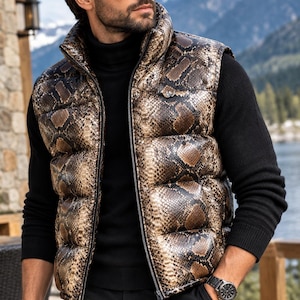 May include: A sleeveless puffer vest featuring a brown and black snakeskin pattern, a high collar, and a full-length front zipper. The vest is worn over a solid black long-sleeve turtleneck sweater paired with black trousers and a black wristwatch.
