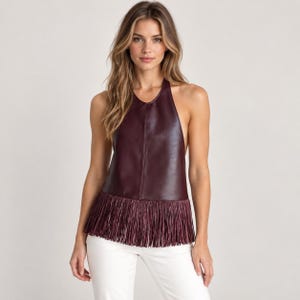 May include: A sleeveless halter-neck top in a deep burgundy shade, made from a smooth, leather-effect material. The garment features a high neckline and a straight hemline finished with a long, matching fringe detail hanging from the bottom edge.