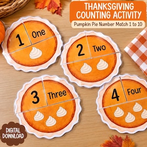 May include: A Thanksgiving counting activity set featuring four circular pumpkin pie cards. Each pie is divided into two pieces, displaying a numeral from 1 to 4, the corresponding written word, and a matching number of whipped cream dollops.
