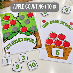 May include: An educational apple counting activity set featuring two laminated sheets with tree and basket illustrations, red apple cutouts, and square number tiles labeled 1 through 10. Text includes APPLE COUNTING 1 TO 10, LETS COLLECT APPLES, and COUNT AND FILL THE BASKET.