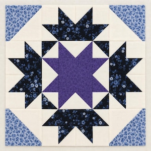 May include: A square quilt block featuring a central purple star surrounded by four dark navy blue floral star points. The corners are accented with light blue floral fabric, and the remaining sections are composed of solid off-white fabric.