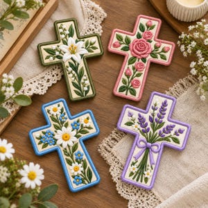 May include: Four decorative cross-shaped wall plaques featuring raised floral designs. One cross is olive green with white lilies, one is pink with pink roses, one is blue with white and blue daisies, and one is purple with lavender sprigs.