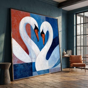 May include: A large square wall art piece featuring two white swans with orange beaks facing each other to form a heart shape. The background is divided into bold blocks of deep red and dark blue, with a textured paint application throughout.