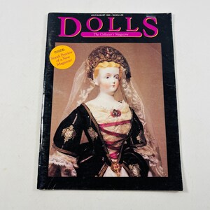 May include: The July/August 1985 issue of DOLLS The Collector's Magazine features a cover image of a doll wearing a black and cream gown with a matching headpiece and veil. A yellow circular sticker on the cover reads Sneak Preview of a New Magazine.