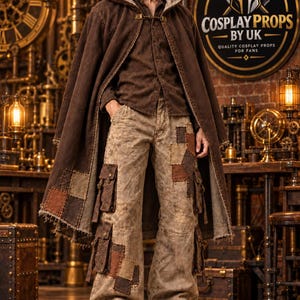 May include: A brown hooded cloak with a metal clasp, a brown button-down shirt, and beige cargo trousers featuring multiple pockets and brown fabric patches. The trousers have a wide-leg fit, and the outfit is completed with brown leather boots.