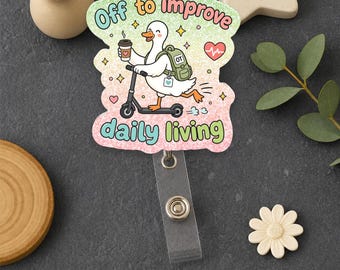 May include: A badge reel featuring a white duck on a scooter, holding a coffee cup and wearing a green backpack labeled OT. The text reads Off to improve daily living. The background is a pastel gradient with hearts and stars, finished with a metal clip.