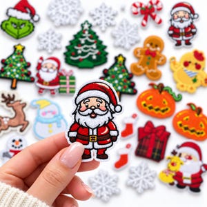 May include: A collection of embroidered holiday-themed patches featuring Santa Claus, Christmas trees, snowflakes, a gingerbread man, pumpkins, a snowman, a reindeer, and gift boxes. One Santa patch is held in the foreground.