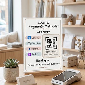 Puede incluir: Un letrero de acrílico transparente sobre una base de madera que muestra métodos de pago aceptados, incluidos Venmo, Cash App, PayPal y Zelle. El letrero incluye un código QR para pagar y el texto Thank you for supporting my smalll bussiness.